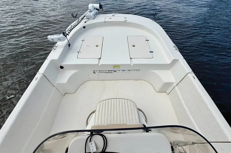 Slide: The Image of 2017 Carolina Skiff 218 DLV boat interior with seating and storage compartments. - 6