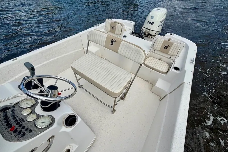 Slide: The Image of 2017 Carolina Skiff 218 DLV boat interior with steering wheel and seating. - 10