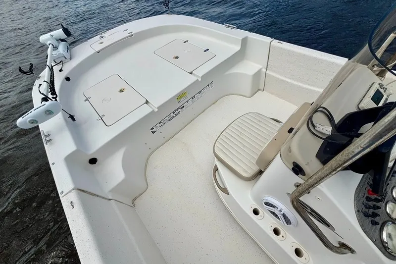Slide: The Image of 2017 Carolina Skiff 218 DLV boat interior with seating and storage compartments. - 9