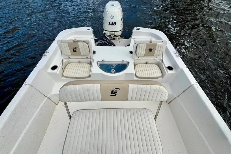 Slide: The Image of 2017 Carolina Skiff 218 DLV boat interior with seating and Suzuki 140 engine. - 11