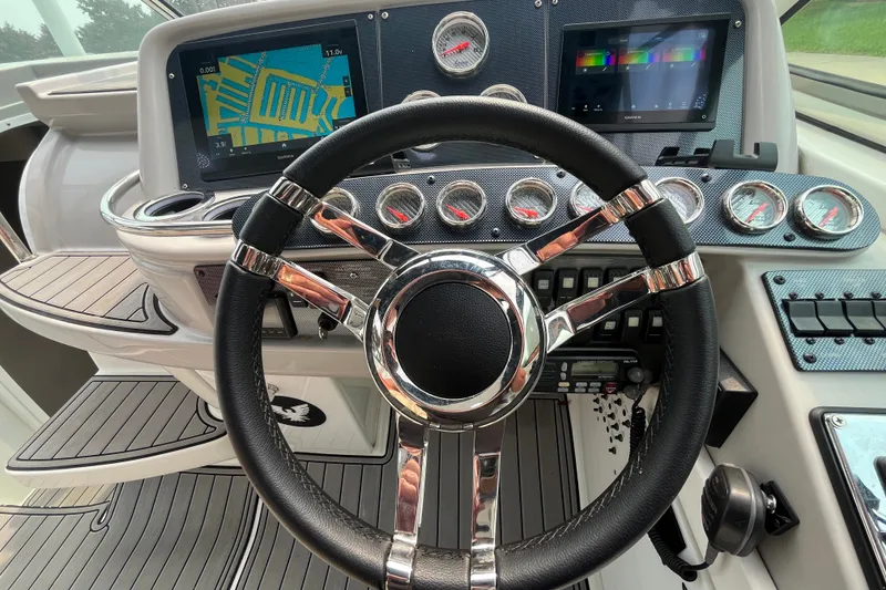 Slide: The Image of Steering wheel and dashboard of a 2006 Formula 370 Super Sport boat. - 3