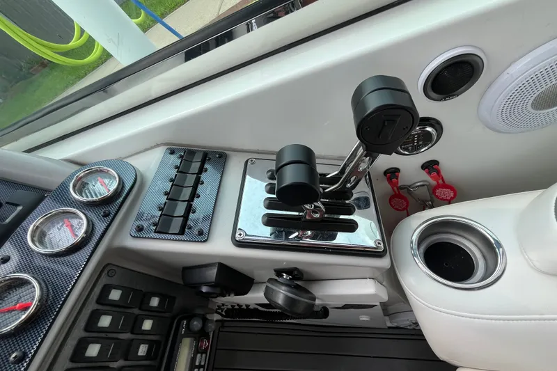 Slide: The Image of Interior controls of a 2006 Formula 370 Super Sport boat, featuring gauges and throttle levers. - 8