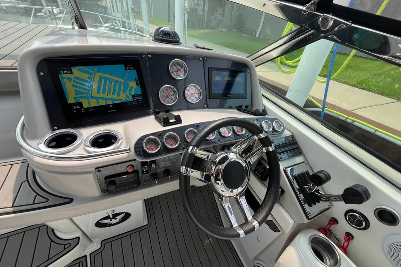 Slide: The Image of Cockpit of a 2006 Formula 370 Super Sport boat with navigation screens and controls. - 2