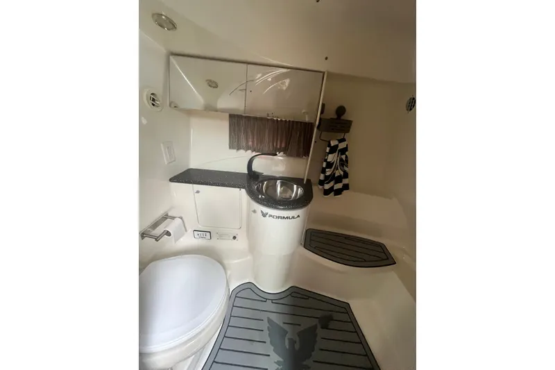 Slide: The Image of 2006 Formula 370 Super Sport boat bathroom interior with sink and toilet. - 18