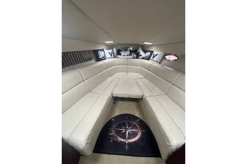 Slide: The Image of Luxurious interior of a 2006 Formula 370 Super Sport boat with white leather seating. - 16