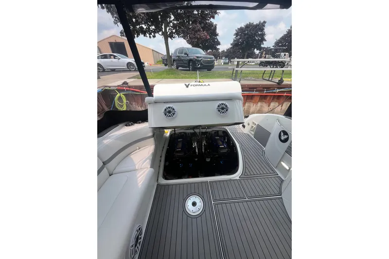 Slide: The Image of 2006 Formula 370 Super Sport boat interior with open engine compartment, docked outdoors. - 11