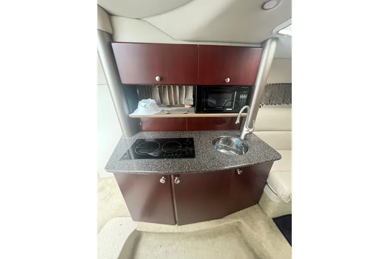 Slide: The Image of 2006 Formula 370 Super Sport yacht kitchenette with stove, sink, and microwave. - 17