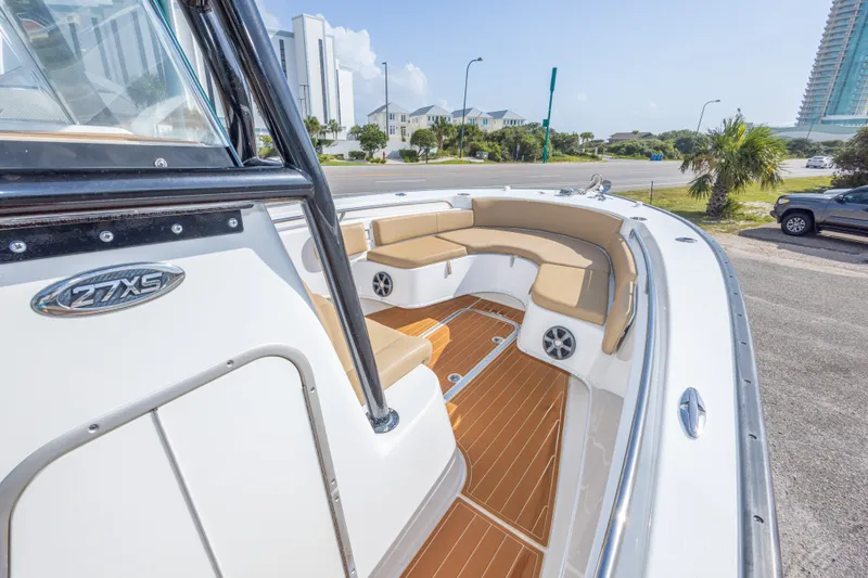 Slide: The Image of 2018 Cape Horn 27XS boat with tan seating and sleek design, docked near modern buildings. - 30