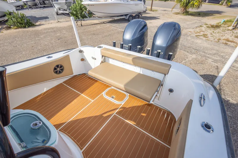 Slide: The Image of 2018 Cape Horn 27XS boat interior with teak flooring and dual outboard engines. - 44