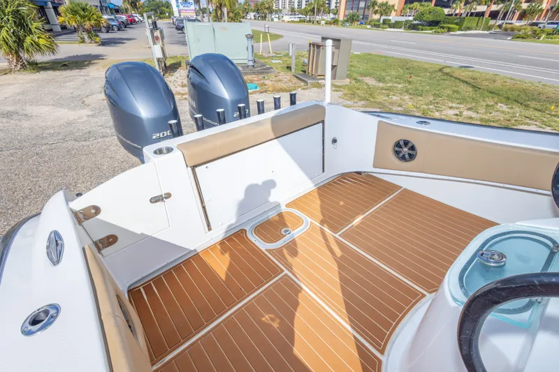 Slide: The Image of 2018 Cape Horn 27XS boat deck with twin engines and teak flooring. - 41