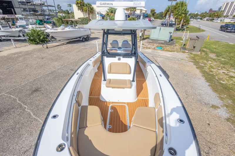 Slide: The Image of 2018 Cape Horn 27XS boat with tan seating and Garmin equipment, docked outdoors. - 34