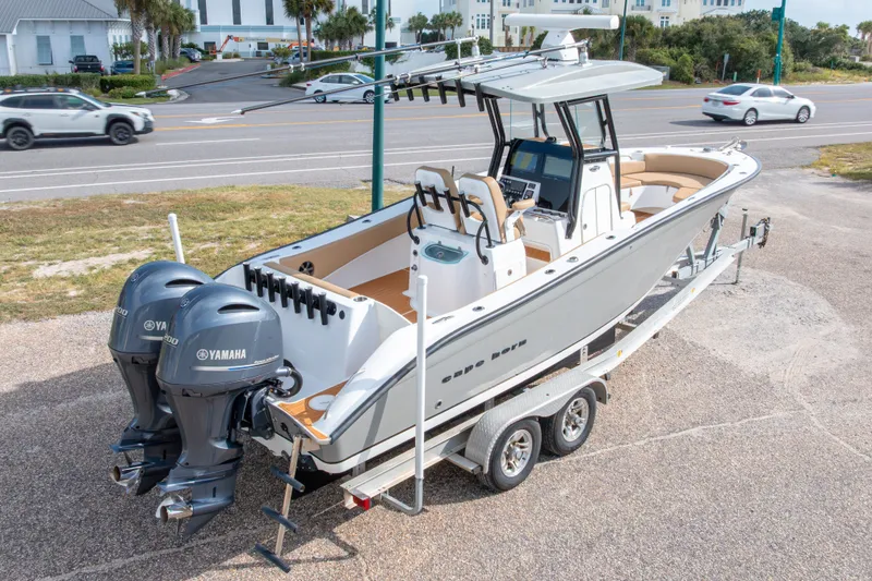 Slide: The Image of 2018 Cape Horn 27XS boat on trailer with dual Yamaha engines, parked near road. - 47