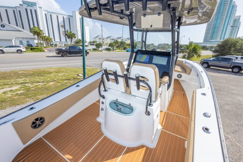 Slide: The Image of 2018 Cape Horn 27XS boat with modern console and seating, parked near a road. - 22