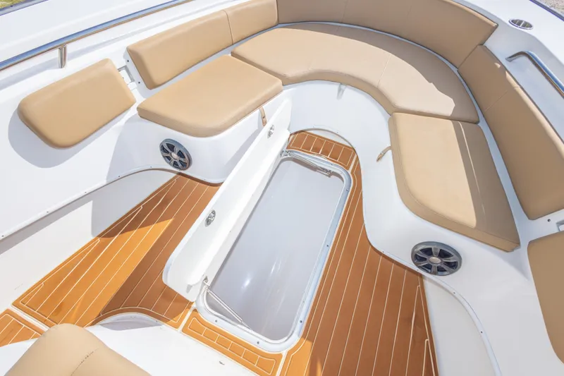 Slide: The Image of 2018 Cape Horn 27XS boat interior with tan seating and wood-style flooring. - 33