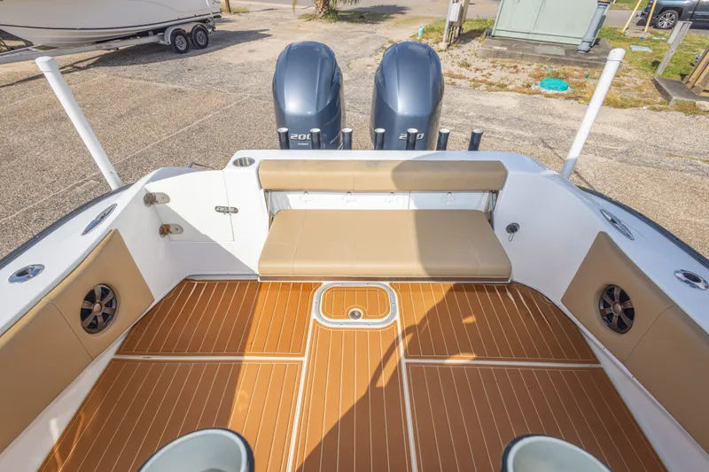 Slide: The Image of 2018 Cape Horn 27XS boat interior with dual engines and cushioned seating. - 45