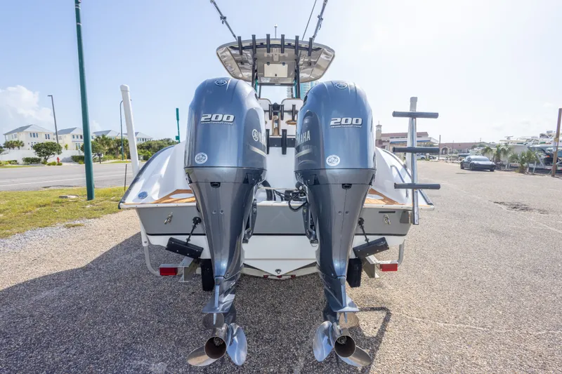 Slide: The Image of 2018 Cape Horn 27XS boat with dual Yamaha 200 outboard engines, parked on a sunny day. - 13