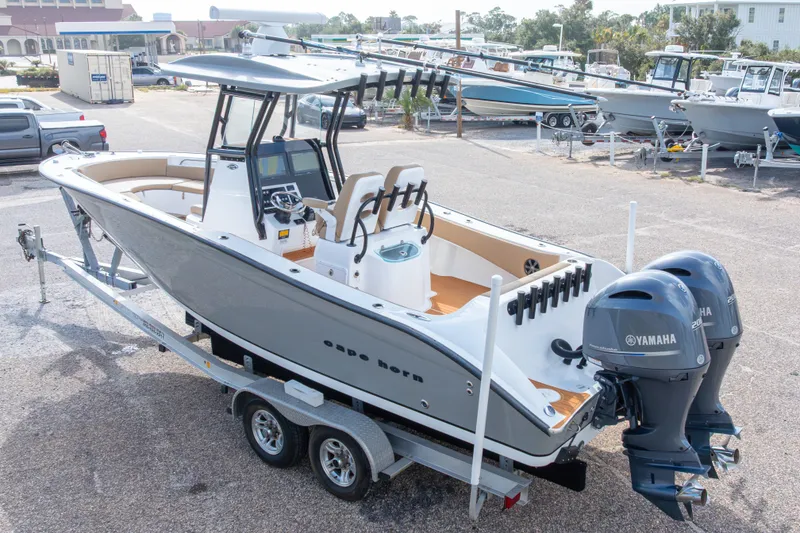 Slide: The Image of 2018 Cape Horn 27XS boat on trailer with dual Yamaha engines in a marina setting. - 49