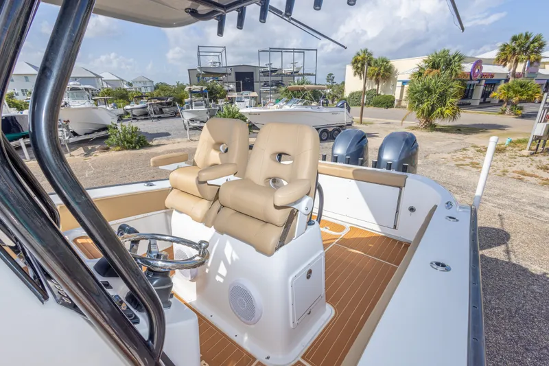 Slide: The Image of 2018 Cape Horn 27XS boat with dual seats and steering wheel, docked outdoors. - 38