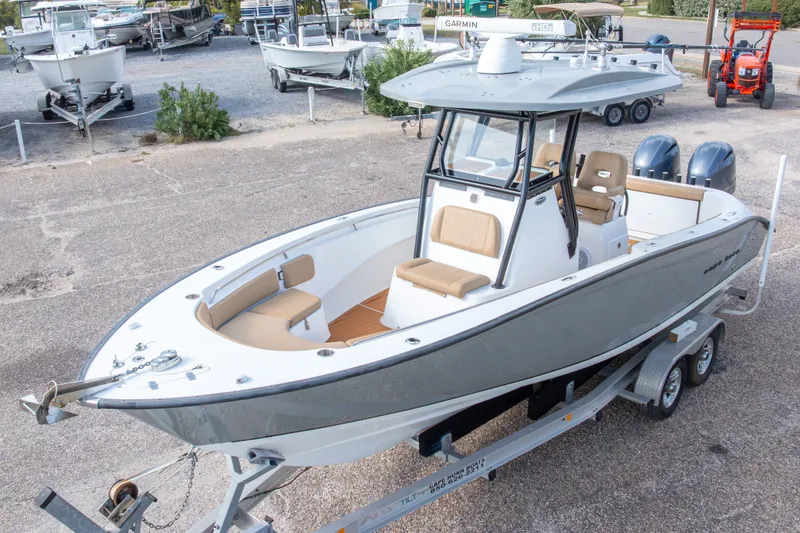 Slide: The Image of 2018 Cape Horn 27XS boat on trailer, featuring dual engines and spacious seating. - 5