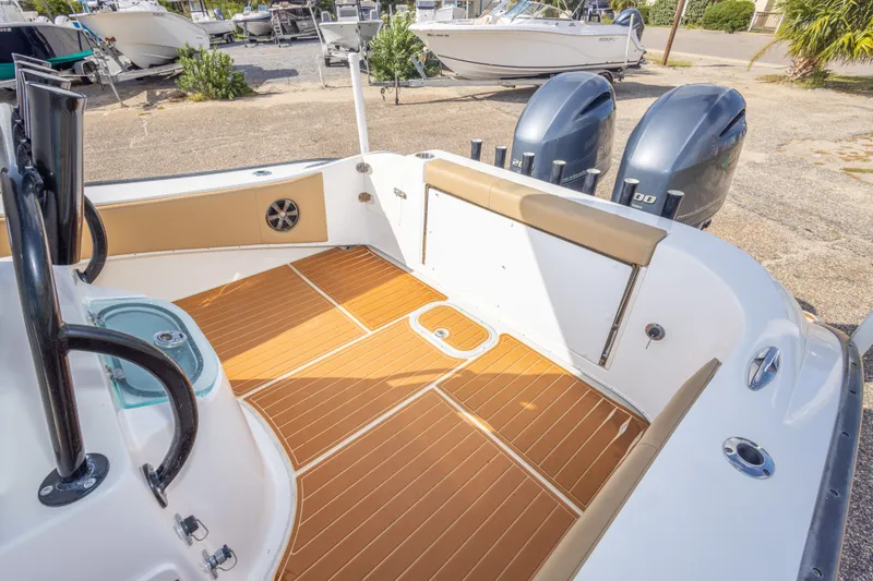 Slide: The Image of 2018 Cape Horn 27XS boat interior with teak flooring and dual outboard motors. - 42