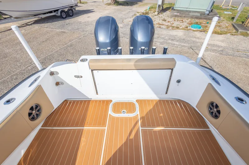 Slide: The Image of 2018 Cape Horn 27XS boat deck with twin engines and teak flooring. - 40