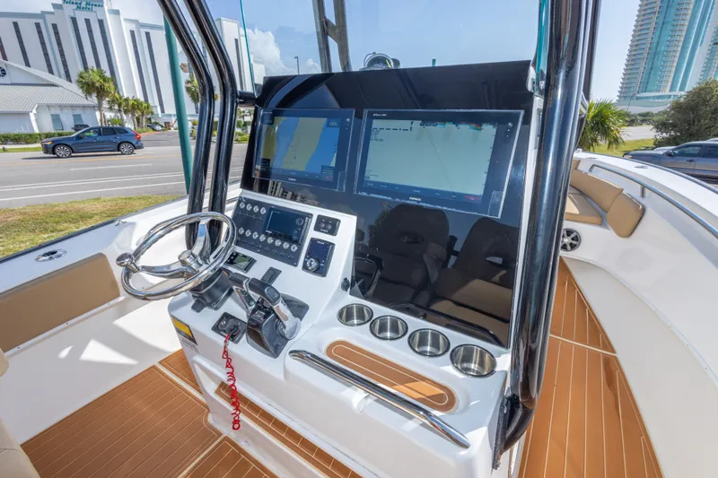 Slide: The Image of 2018 Cape Horn 27XS boat cockpit with modern navigation system and steering wheel. - 29