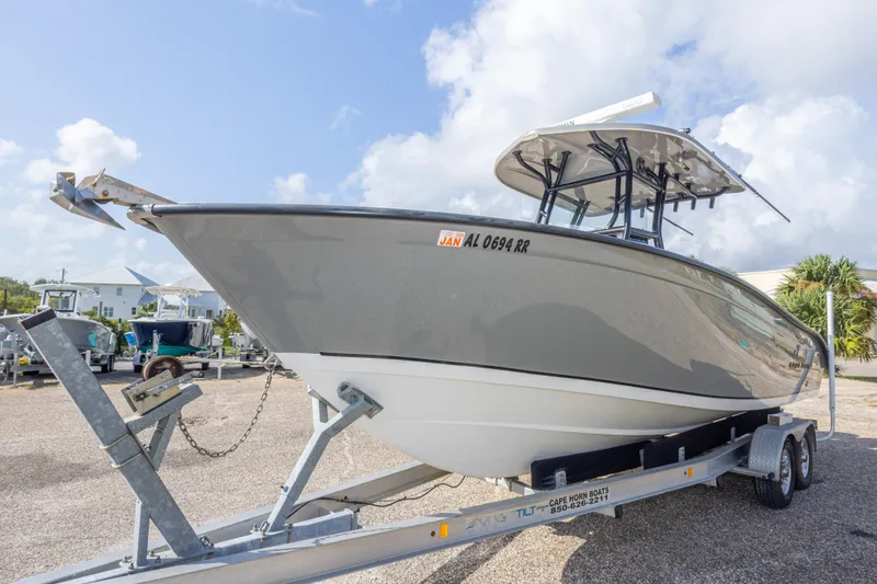Slide: The Image of 2018 Cape Horn 27XS boat on trailer under a clear blue sky. - 16