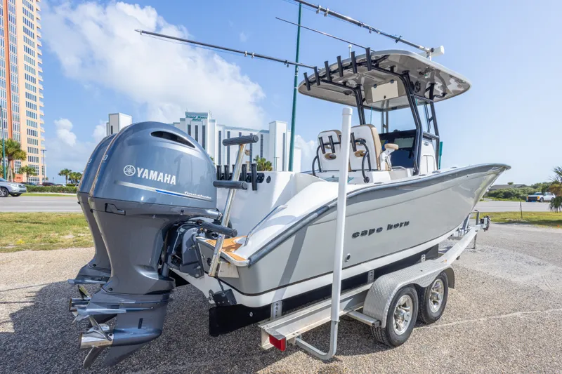 Slide: The Image of 2018 Cape Horn 27XS boat with Yamaha engines on a trailer, parked outdoors. - 11
