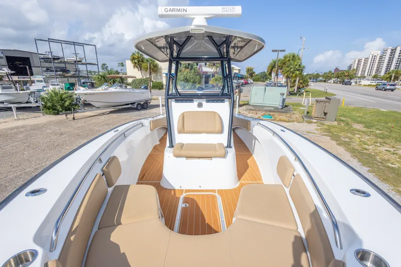 Slide: The Image of 2018 Cape Horn 27XS boat with tan seating and Garmin equipment, docked outdoors. - 35