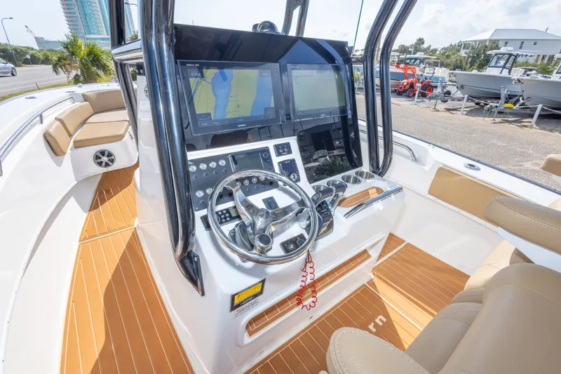 Slide: The Image of 2018 Cape Horn 27XS boat cockpit with dual screens and modern steering controls. - 28