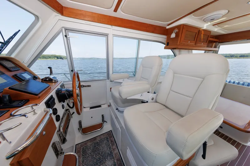 Slide: The Image of Interior of 2020 Back Cove 41 boat with plush seating and navigation controls. - 18