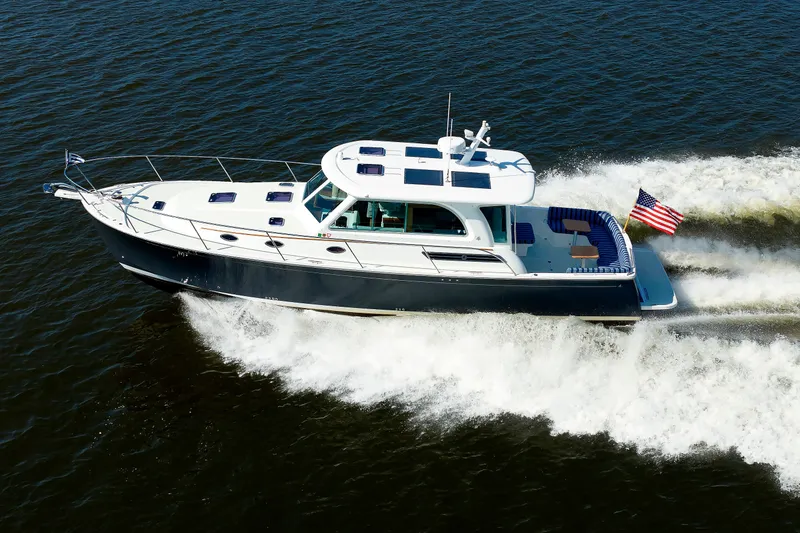 Slide: The Image of 2020 Back Cove 41 yacht cruising on open water with American flag. - 52