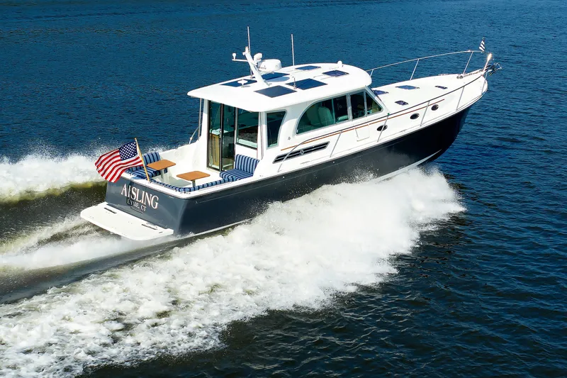 Slide: The Image of 2020 Back Cove 41 yacht cruising on open water with American flag displayed. - 51