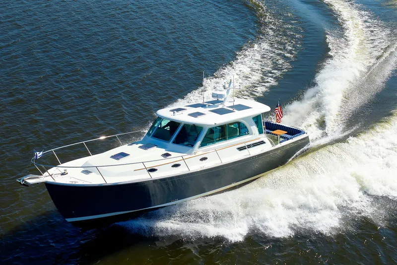 Slide: The Image of 2020 Back Cove 41 yacht cruising on open water, creating a dynamic wake. - 55