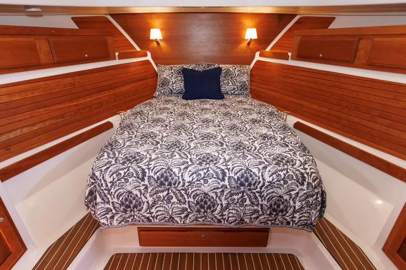Slide: The Image of Luxurious cabin interior of 2020 Back Cove 41 yacht with elegant bedding and wooden accents. - 3