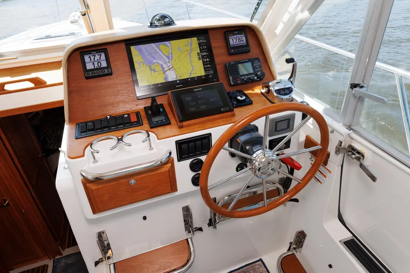 Slide: The Image of Helm of 2020 Back Cove 41 boat with navigation instruments and wooden steering wheel. - 21
