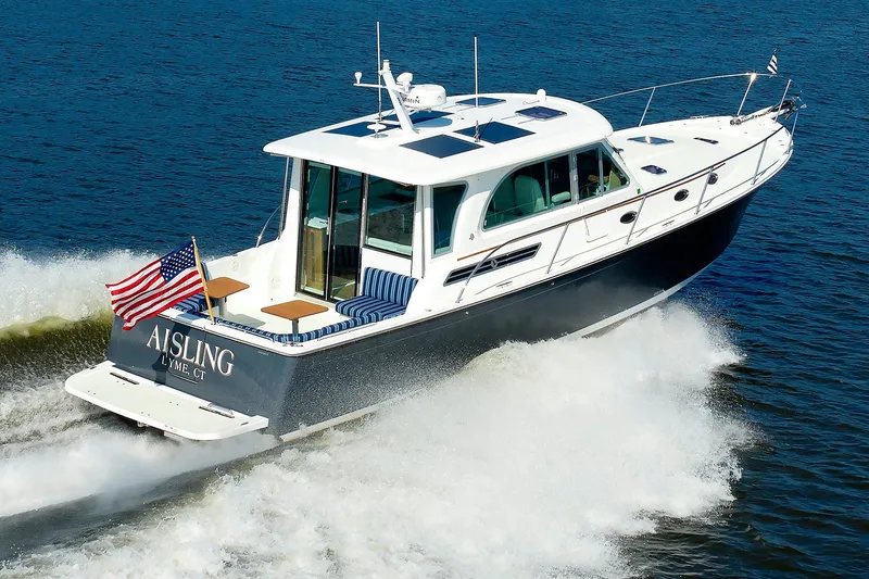 The Image of 2020 Back Cove 41 yacht cruising on open water, displaying American flag. - 0