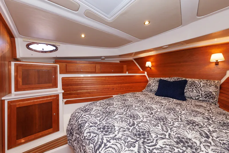 Slide: The Image of Luxurious cabin interior of 2020 Back Cove 41 yacht with elegant wood paneling and cozy bedding. - 31