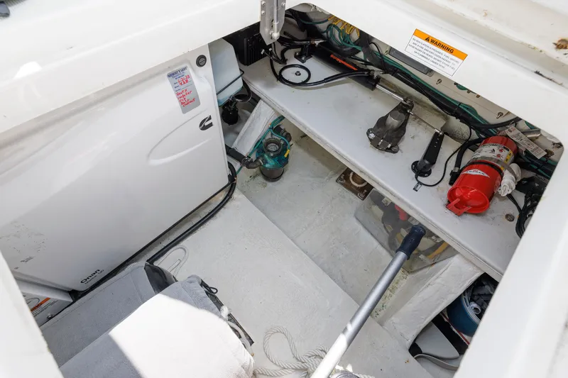 Slide: The Image of Engine compartment of a 2020 Back Cove 41 boat, featuring equipment and safety gear. - 37