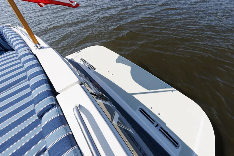 Slide: The Image of 2020 Back Cove 41 yacht with striped seating and American flag on calm water. - 43
