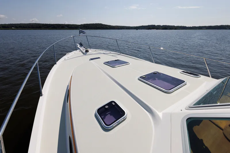 Slide: The Image of 2020 Back Cove 41 yacht deck on calm water, showcasing sleek design and spacious layout. - 47