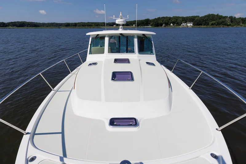 Slide: The Image of 2020 Back Cove 41 yacht on calm water, showcasing sleek deck design and spacious layout. - 49