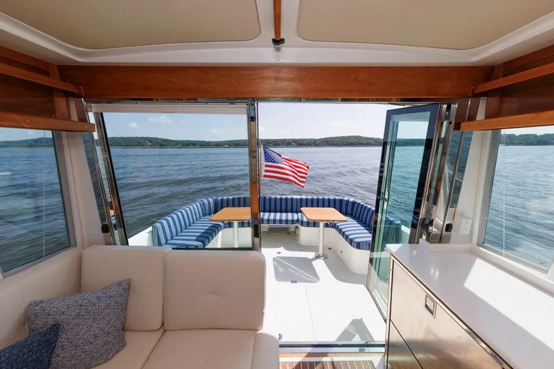 Slide: The Image of Interior view of 2020 Back Cove 41 yacht with American flag and scenic water backdrop. - 33