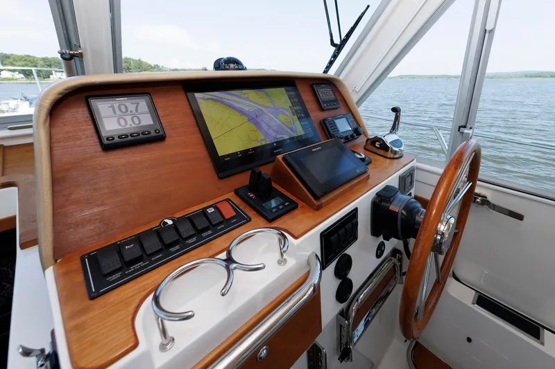Slide: The Image of Helm of 2020 Back Cove 41 boat with navigation equipment and wooden steering wheel. - 20