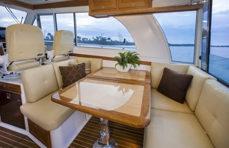 Slide: The Image of Manufacturer Provided Image: Luxurious interior of 2020 Back Cove 41 yacht with dining area and scenic window views. - 14