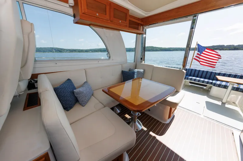 Slide: The Image of Luxurious interior of 2020 Back Cove 41 yacht with seating, table, and American flag. - 15