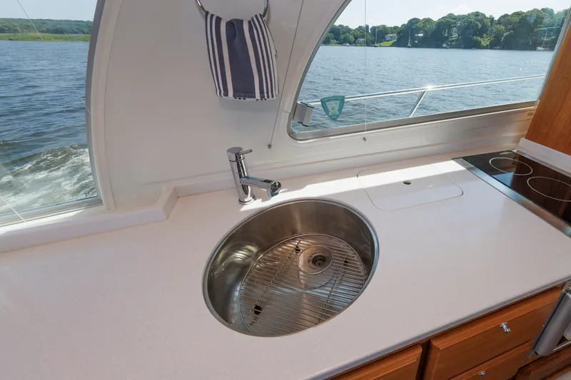 Slide: The Image of Modern kitchen sink on 2020 Back Cove 41 yacht with scenic water view. - 10