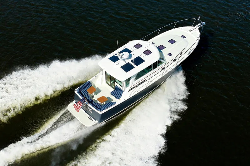 Slide: The Image of 2020 Back Cove 41 yacht cruising on open water, aerial view. - 53