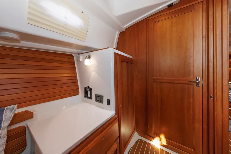 Slide: The Image of Interior of 2020 Back Cove 41 yacht featuring wooden cabinetry and modern lighting. - 26