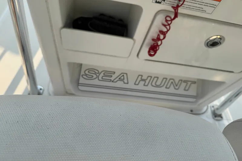 Slide: The Image of 2020 Sea Hunt Ultra 211 boat interior with logo and storage compartment. - 16